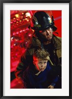 Close-up of a firefighter carrying a boy Fine Art Print