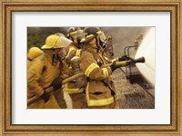 Side profile of a group of firefighters holding water hoses Fine Art Print