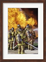 Rear view of a group of firefighters extinguishing a fire vertical Fine Art Print