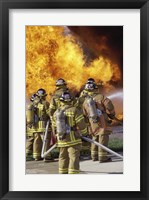 Rear view of a group of firefighters extinguishing a fire vertical Fine Art Print