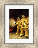 Rear view of three firefighters extinguishing a fire Fine Art Print