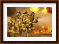Rear view of a group of firefighters extinguishing a fire and flames Fine Art Print