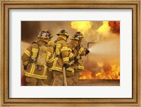 Rear view of a group of firefighters extinguishing a fire and flames Fine Art Print