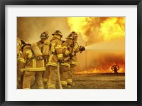 Rear view of a group of firefighters extinguishing a fire Fine Art Print