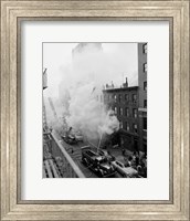 New York City, Fire on East 47th Street, with fire engines shooting water on burning building Fine Art Print