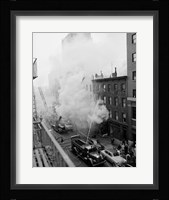 New York City, Fire on East 47th Street, with fire engines shooting water on burning building Fine Art Print