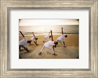 Group of people performing yoga on the beach Fine Art Print