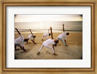 Group of people performing yoga on the beach Fine Art Print
