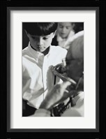 Male doctor listening to a boy's heartbeat Fine Art Print
