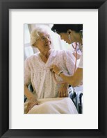 Female nurse checking a female patient's heartbeat Fine Art Print