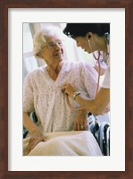 Female nurse checking a female patient's heartbeat Fine Art Print