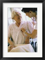 Female nurse checking a female patient's heartbeat Fine Art Print