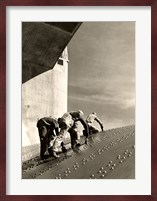 Three construction workers putting a coat of paint on a slanted wall of riveted-steel plates on the Hoover Dam spillway Fine Art Print