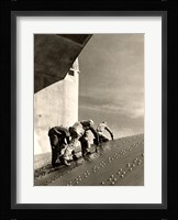 Three construction workers putting a coat of paint on a slanted wall of riveted-steel plates on the Hoover Dam spillway Framed Print