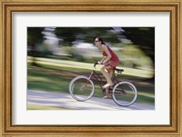 Side profile of a young woman riding a bicycle Fine Art Print