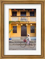 Person riding a bicycle in front of a cafe, Hoi An, Vietnam Fine Art Print