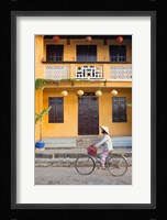 Person riding a bicycle in front of a cafe, Hoi An, Vietnam Fine Art Print