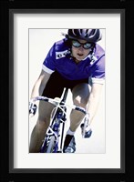 Young woman riding a bicycle Framed Print