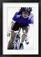 Young woman riding a bicycle Framed Print