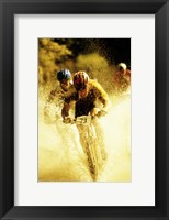 Young men riding bicycles through water Fine Art Print