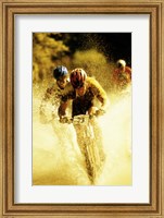 Young men riding bicycles through water Fine Art Print