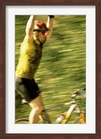 Young man sitting on a bicycle with his arms raised Fine Art Print