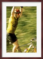 Young man sitting on a bicycle with his arms raised Fine Art Print