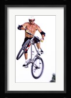 Young man on a bicycle in mid-air Framed Print