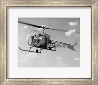Low angle view of two people sitting in a helicopter, Bell 47G-2 Fine Art Print