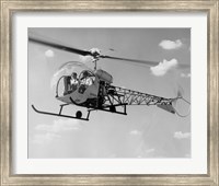 Low angle view of two people sitting in a helicopter, Bell 47G-2 Fine Art Print