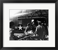 Army soldiers carrying an injured person in a helicopter Fine Art Print