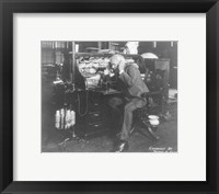 Thomas Alva Edison using his dicatating machine Framed Print