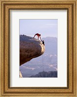 Side profile of a young man pulling a young woman onto a rock Fine Art Print