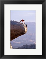 Side profile of a young man pulling a young woman onto a rock Fine Art Print