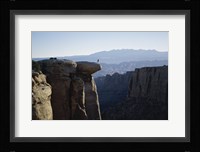 Side profile of a young man pulling a young woman onto a rock Fine Art Print