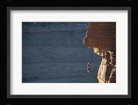 Man hanging from a rope on the edge of a cliff Fine Art Print