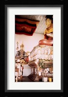 A Young Girl Praying in Front of a Giant Buddha Statue Fine Art Print