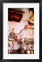 A Young Girl Praying in Front of a Giant Buddha Statue Fine Art Print