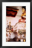 A Young Girl Praying in Front of a Giant Buddha Statue Fine Art Print