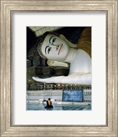 Monk Sitting in Front of a Buddha Statue Fine Art Print