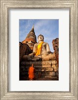 Monk praying in front of a statue of Buddha Fine Art Print