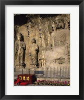 Buddha Statue in a Cave, Longmen Caves, Luoyang, China with Flowers Framed Print