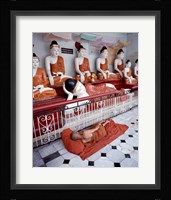 Monk Sleeping in Front of Buddha Statues Fine Art Print