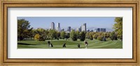 Four people playing golf with buildings in the background, Denver, Colorado, USA Fine Art Print