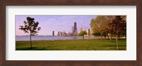 Trees in a park with lake and buildings in the background, Lincoln Park, Lake Michigan, Chicago, Illinois, USA Fine Art Print
