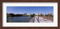Bicyclists along the Sacramento River with Tower Bridge in background, Sacramento, Sacramento County, California, USA Fine Art Print