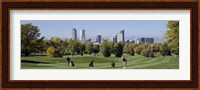 Four people playing golf with buildings in the background, Denver, Colorado, USA Fine Art Print