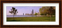 Trees in a park with lake and buildings in the background, Lincoln Park, Lake Michigan, Chicago, Illinois, USA Fine Art Print