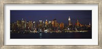 Skyscrapers lit up at night in a city, Manhattan, New York City, New York State, USA Fine Art Print