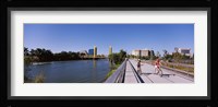 Bicyclists along the Sacramento River with Tower Bridge in background, Sacramento, Sacramento County, California, USA Fine Art Print